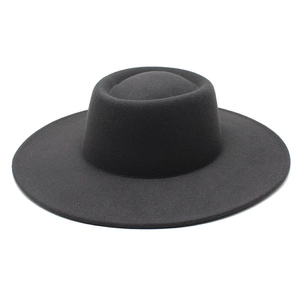 Detail of a vintage black wool felt flat top wide brim hat with a smooth matte finish