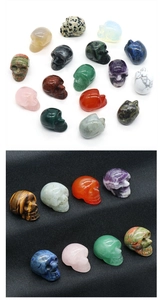 Various 1-inch carved crystal skulls made of tiger eye, rose quartz and agate gemstones