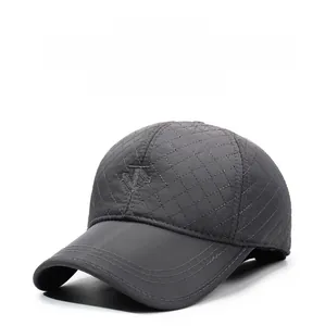 Detailed view of winter baseball cap with diamond quilting and protective ear flaps