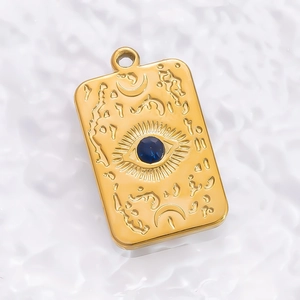 Macro detail of 18K gold starfish mirror pendant with blue stone and celestial relief