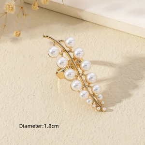 Close-up of golden pearl ring with 1.8cm diameter and elegant floral background