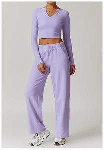 Detail of light purple yoga set featuring a v-neck cropped top and elastic joggers