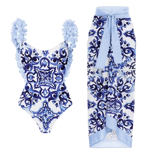 Detail view of Majolica blue tile print bikini set with 3D floral appliques and wrap skirt