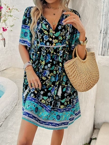 Detail of bohemian floral dress with V-neck, buttons, and decorative tassel drawstring