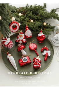 Detailed view of red and white glitter Christmas ornaments set on dark green tray