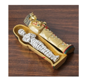 Detailed view of an ancient Egyptian golden sarcophagus with a white mummy figurine
