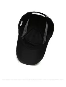 Detail of internal breathable white mesh and premium lining in a black sport baseball cap