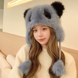 Detail of grey-blue panda plush trapper hat with furry ears and long pom-pom drawstrings