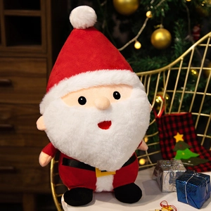 Plush Santa Claus doll with red hat and white beard in festive Christmas setting