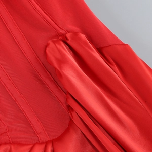Detail of red mesh fabric stitched with silky satin on an elegant evening gown