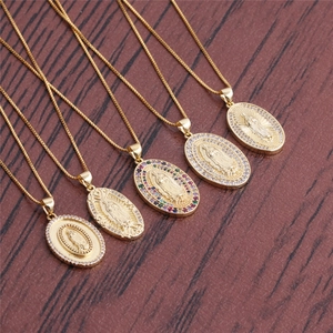 Detailed macro of gold plated oval necklaces with Virgin Mary embossed pendants