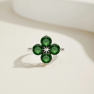 Close-up of S925 silver four-leaf clover ring with green zircons and a central star