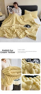 Detailed view of the custard yellow faux rabbit fur blanket with carved striped texture