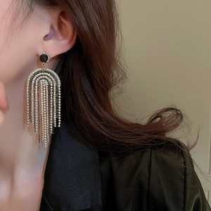 Elegant bohemian long rhinestone tassel earrings in silver and black on a model