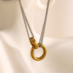 Macro shot of 18K gold plated double interlocking rings on a silver chain necklace