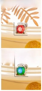 Detailed size display of snake-shaped titanium steel studs with red and green gemstones