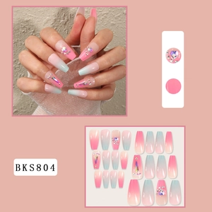Detail view of pink and blue gradient long coffin fake nails with heart rhinestones