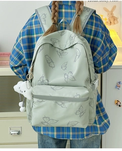 Detailed back view of mint green butterfly backpack featuring a large main compartment