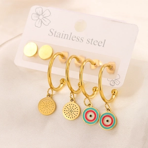 Detail of 18K gold plated stainless steel earring set with enamel charms on white silk
