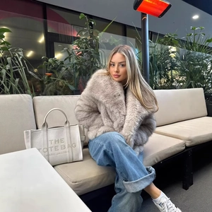 Stylish light gray faux fur coat with oversized lapels and casual outdoor urban styling