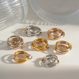 Three-tone interlocking stainless steel band rings in gold, silver and rose gold finishes