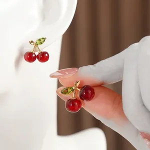 Elegant red cherry stud earrings with green zircon leaves and gold plated metal finish