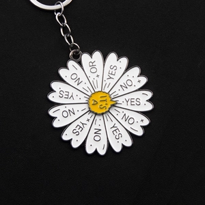 Macro detail of daisy decision maker keychain with yes no or text on metal petals