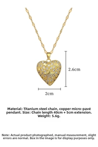Close-up of heart pendant with encrusted diamonds and gold stars on a steel chain
