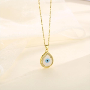 Golden teardrop evil eye necklace with blue zircon and pavé crystals on white silk