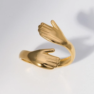 Adjustable gold hugging hands ring in stainless steel shown at a 45-degree angle