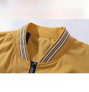 Detail of striped ribbed collar and zipper on yellow bomber jacket for men