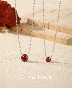 Macro shot of S925 sterling silver necklaces with rose-cut pomegranate red stone pendants