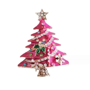 Pink enamel Christmas tree brooch with colorful rhinestones on a white background