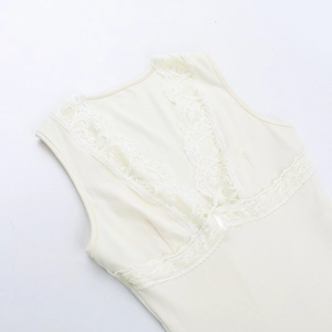 Detailed view of beige lace trim on the neckline of a soft knit sleeveless top