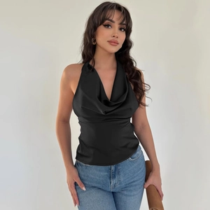 Detail of black satin halter top with cowl neck design and smooth glossy fabric texture