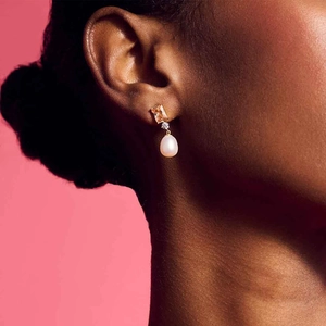 Detail of drop earring with champagne rectangle gemstone and white waterdrop pearl