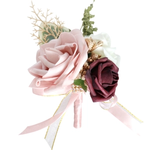 Artificial wedding boutonniere featuring pink and wine red roses with golden leaf accents