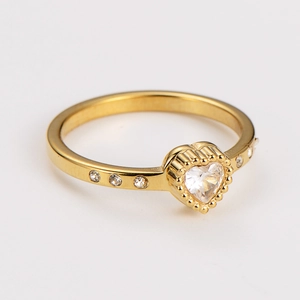 Close-up of heart-shaped zircon gold ring with small pavé side diamonds