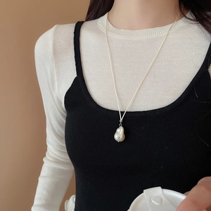Baroque irregular pearl pendant necklace shown on a model with minimalist style