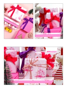 Macro view of pink Christmas wrapping paper set with reindeer patterns and silk ribbons