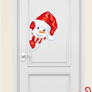 Detailed view of festive snowman wall sticker with red scarf on a white wooden door