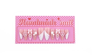 Detail of handmade pink and white press-on nails with 3D bows and pearls in size M