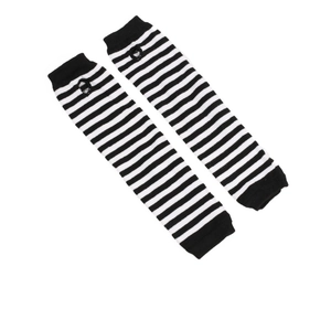 Close-up of black and white striped knitted arm warmers with thumb holes in punk Y2K style