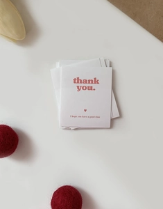 Detail of white rectangular 'thank you' packaging stickers with a pink heart and message
