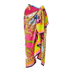 Close-up of sarong wrap with bright baroque chain, leopard print and palm leaf motifs
