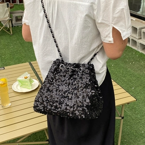Elegant black sequin bucket bag with chain strap for luxury outdoor tea party look