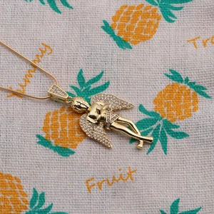 Gold plated angel pendant necklace with shimmering zircon wings on a delicate box chain