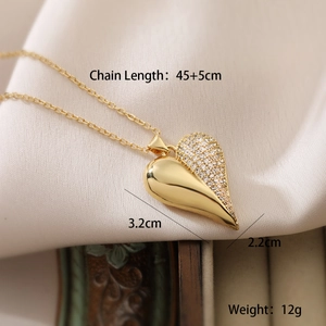 Macro shot of 18K gold plated heart pendant with sparkling white cubic zirconia inlay