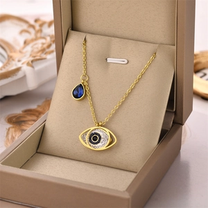 Golden Evil Eye necklace with blue crystals and teardrop charm in a luxury gift box
