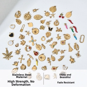Detail of assorted golden stainless steel pendants with heart, star and sun shapes